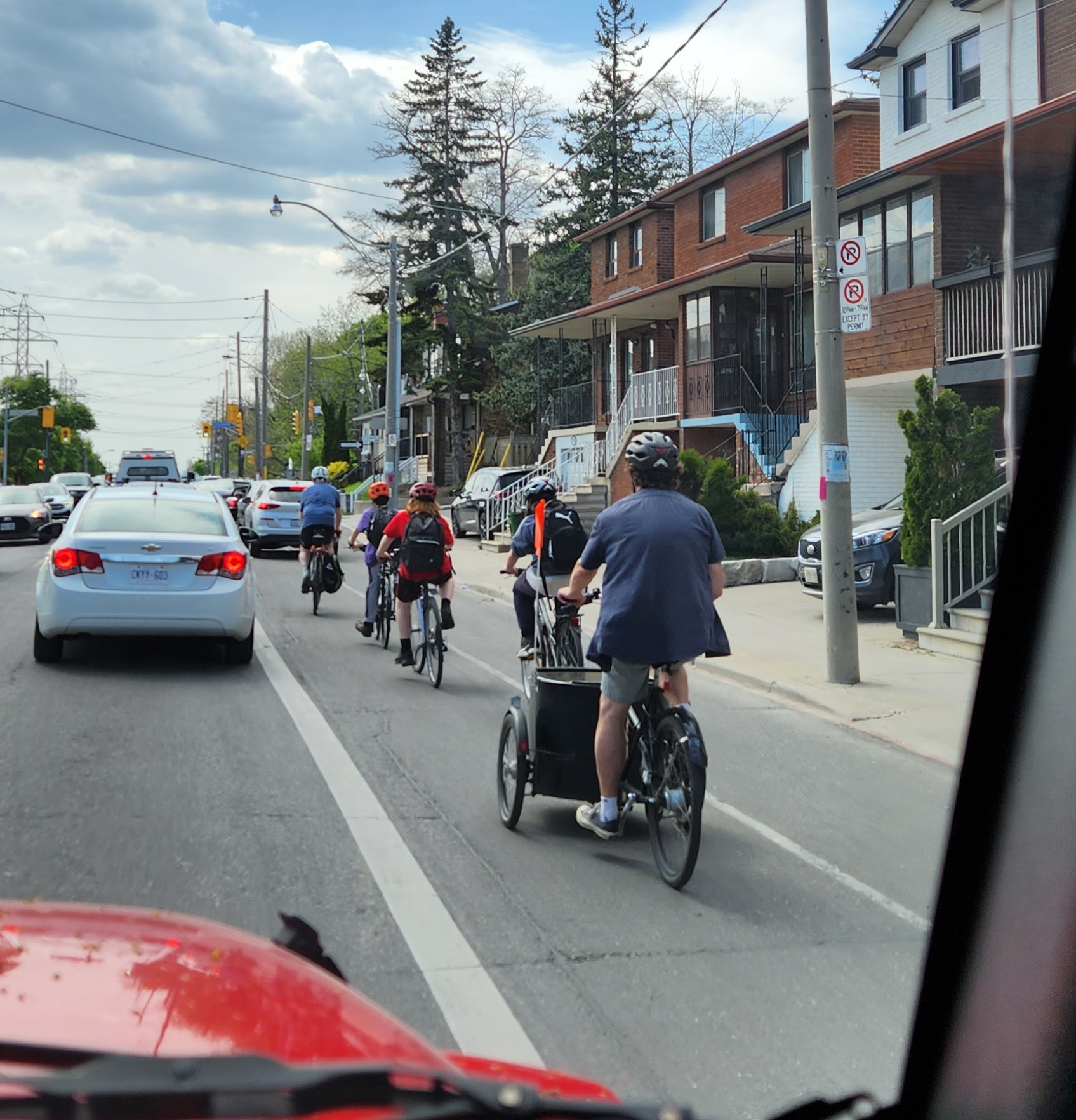 A Toronto bike bus in action on a busy street. The program required only minimal start-up funding, for supplies like safety vests and repair kits. Image credit: Lanrick Bennett Jr.